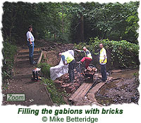 Filling the gabions with bricks