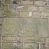 Commemorative stone plaque within the bath house